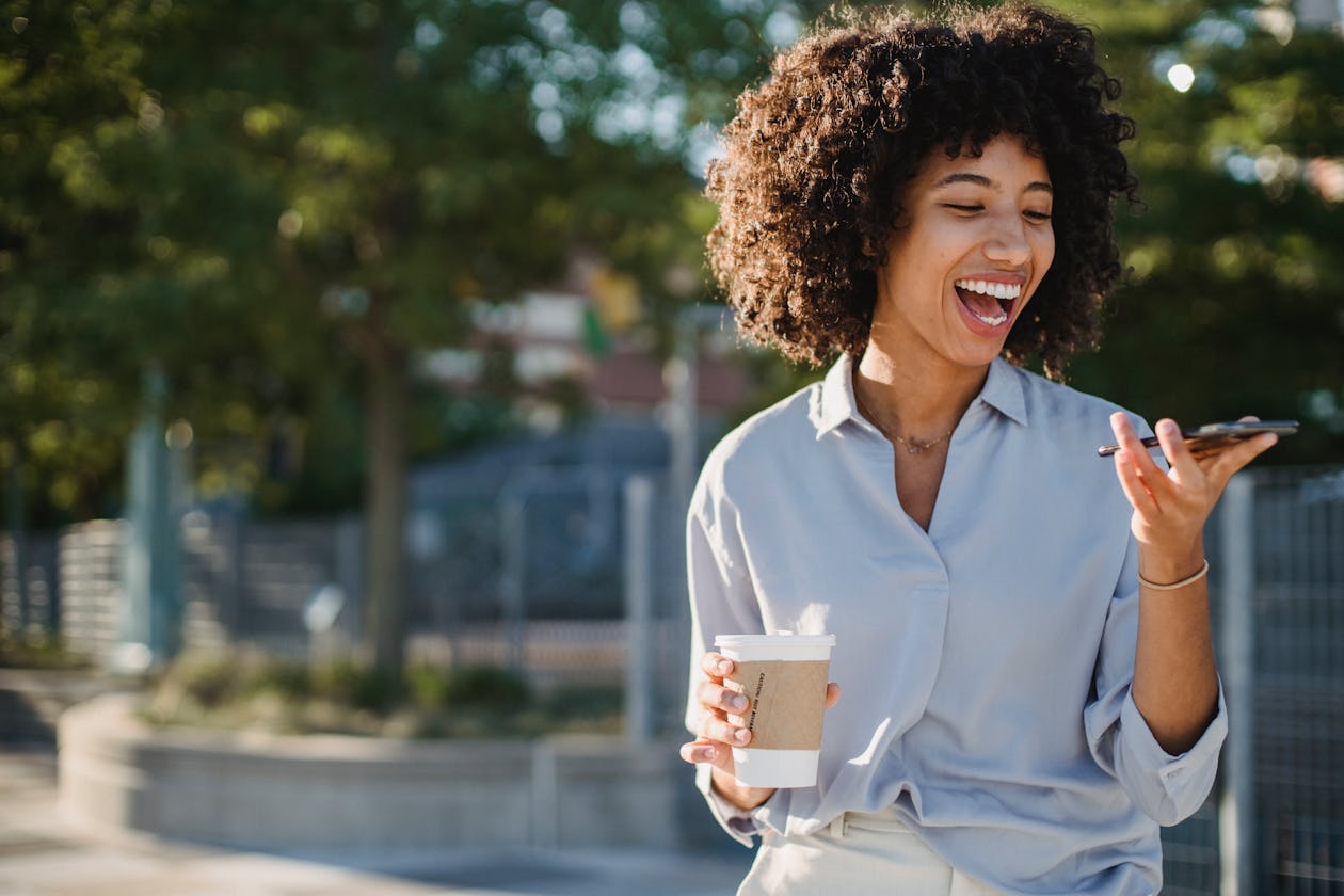 Glad person med mobil och kaffe — gratis adressändring enkelt på telefonen